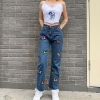 Blue high-waisted denim jeans with butterfly print and tassel details, offering a chic, streetwear style for women. 