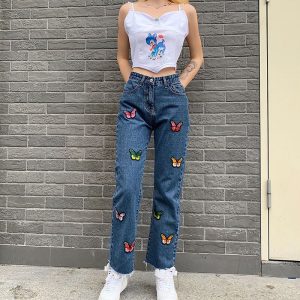 Blue high-waisted denim jeans with butterfly print and tassel details, offering a chic, streetwear style for women. 