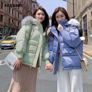 Stylish women's oversized winter down coat with fur collar, hooded design, and thick white duck down filling, perfect for chilly weather. 
