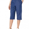 A pair of Alfred Dunner ladies’ petite denim capris featuring a classic elastic waistband and soft cotton fabric, styled casually with a light top in a cozy outdoor setting. 
